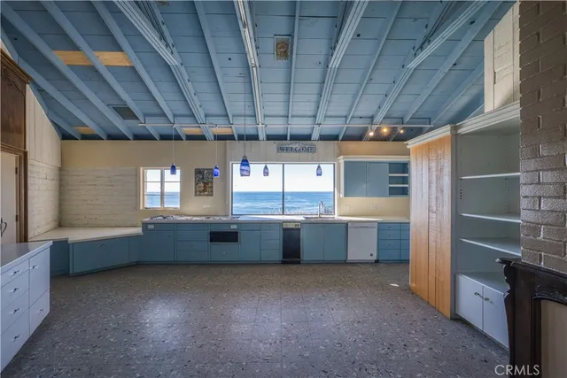 a kitchen with granite countertop a sink and wooden cabinets