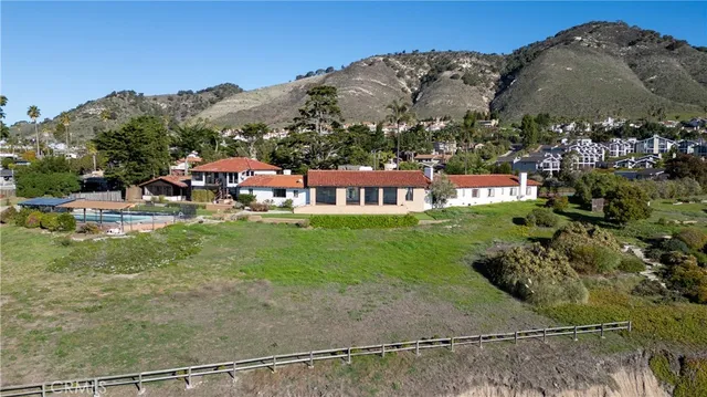 a view of swimming pool with a yard and mountain view in back
