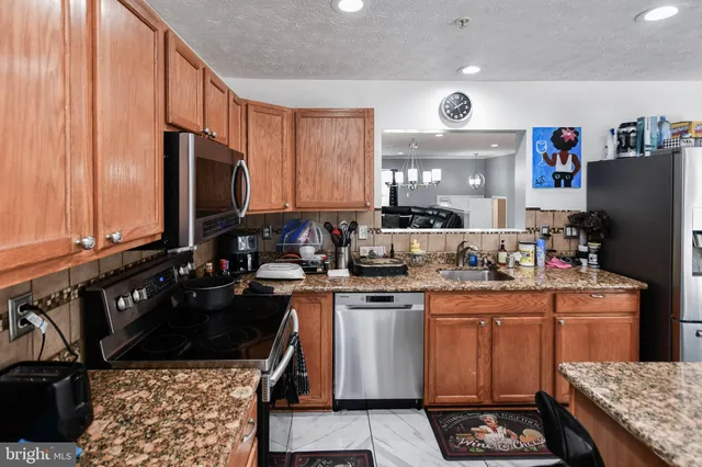 a kitchen with a sink stove and refrigerator