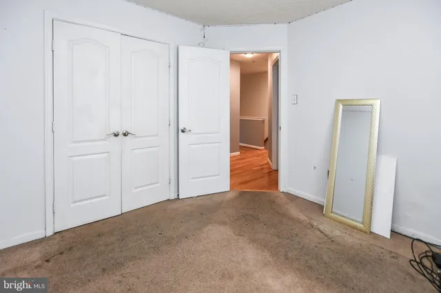 a view of a hallway with wooden floor and entryway