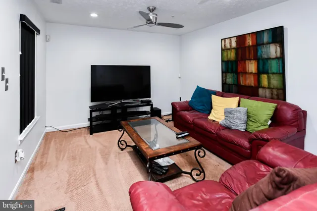 a white toilet sitting next to a white wall