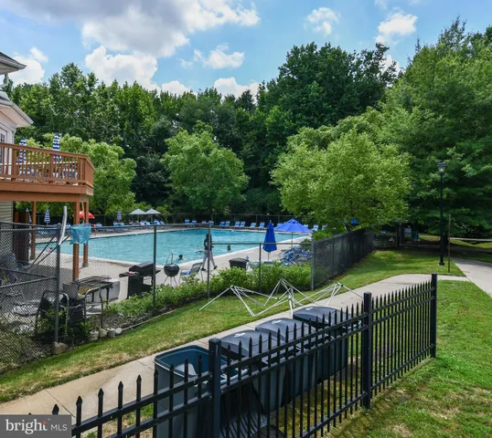 a view of a chair and table in the back yard of the house