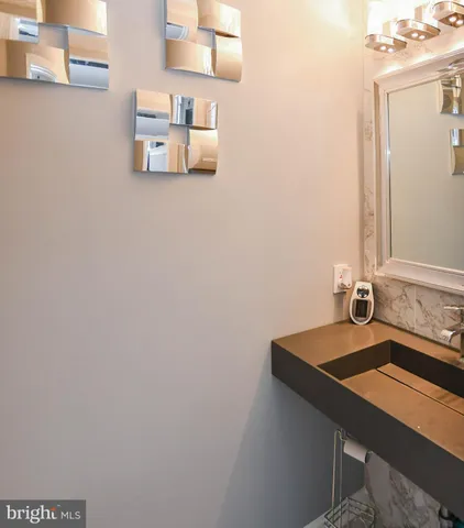 a room with a sink and a mirror