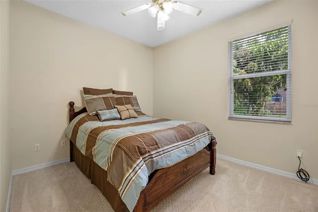 a bed sitting in a bedroom next to a window