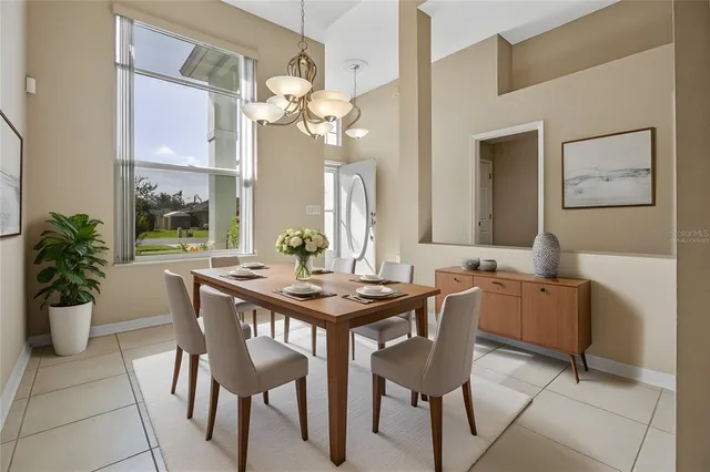 a view of a dining room with furniture and chandelier