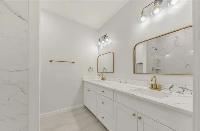 a bathroom with double sink and a mirror