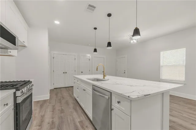a kitchen with a sink a stove and a refrigerator
