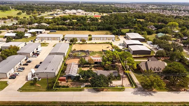 an aerial view of residential houses with yard