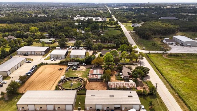an aerial view of a residential houses with outdoor space