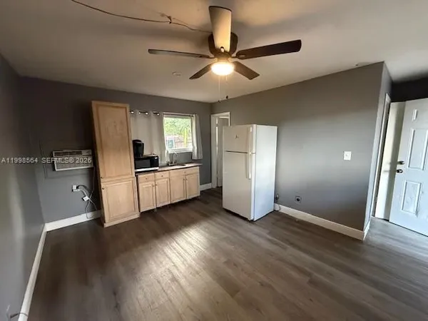 a view of a kitchen with a sink and a refrigerator
