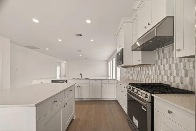 a kitchen with a sink stove and cabinets