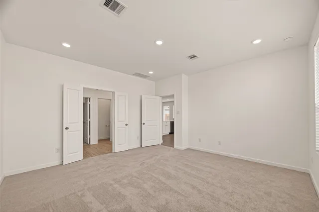 a spacious bathroom with a double vanity sink a mirror and shower