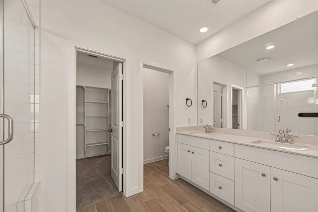 a bathroom with a glass shower door and a shower