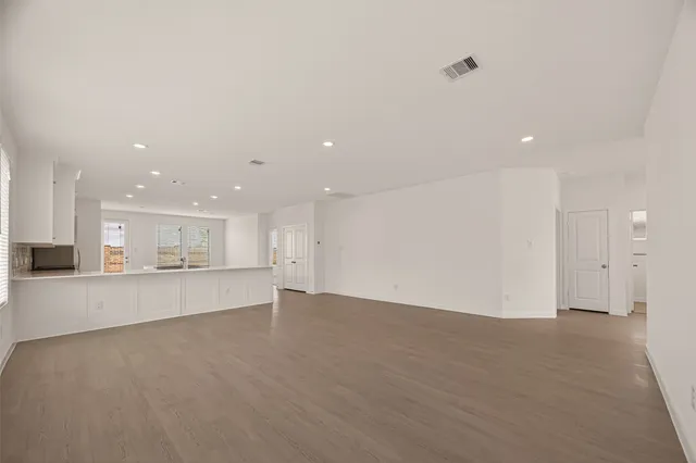a view of a kitchen with a sink and a refrigerator