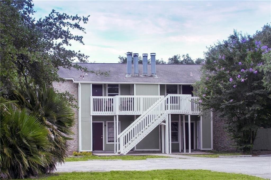 Rear view of house with a patio, stairs, and a wooden deck