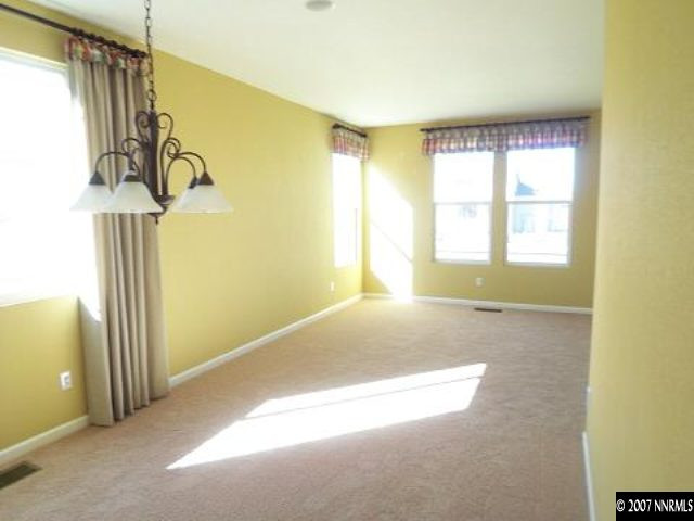 9006 Mahon Drive Reno, NV 89506 - Photo 3 of 9 a view of empty room with windows