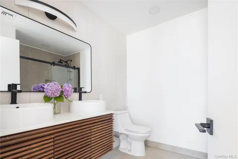 a bathroom with a sink toilet and mirror