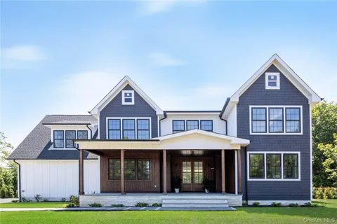 a front view of a house with yard and garage