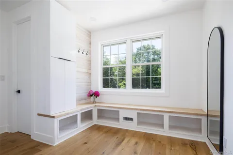a kitchen with stainless steel appliances white cabinets and wooden floor