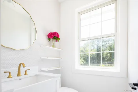 a bathroom with a sink and a window