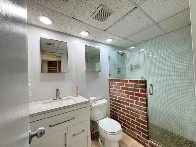 a bathroom with a toilet sink shower and mirror