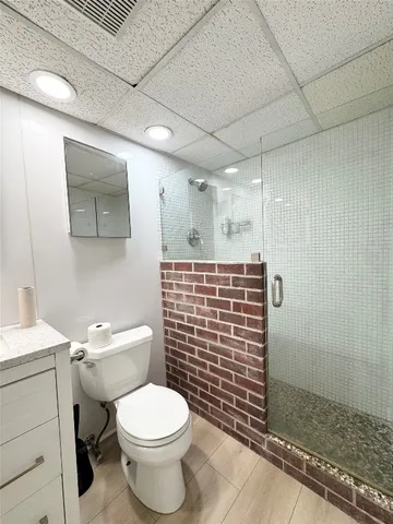 a bathroom with a toilet and shower