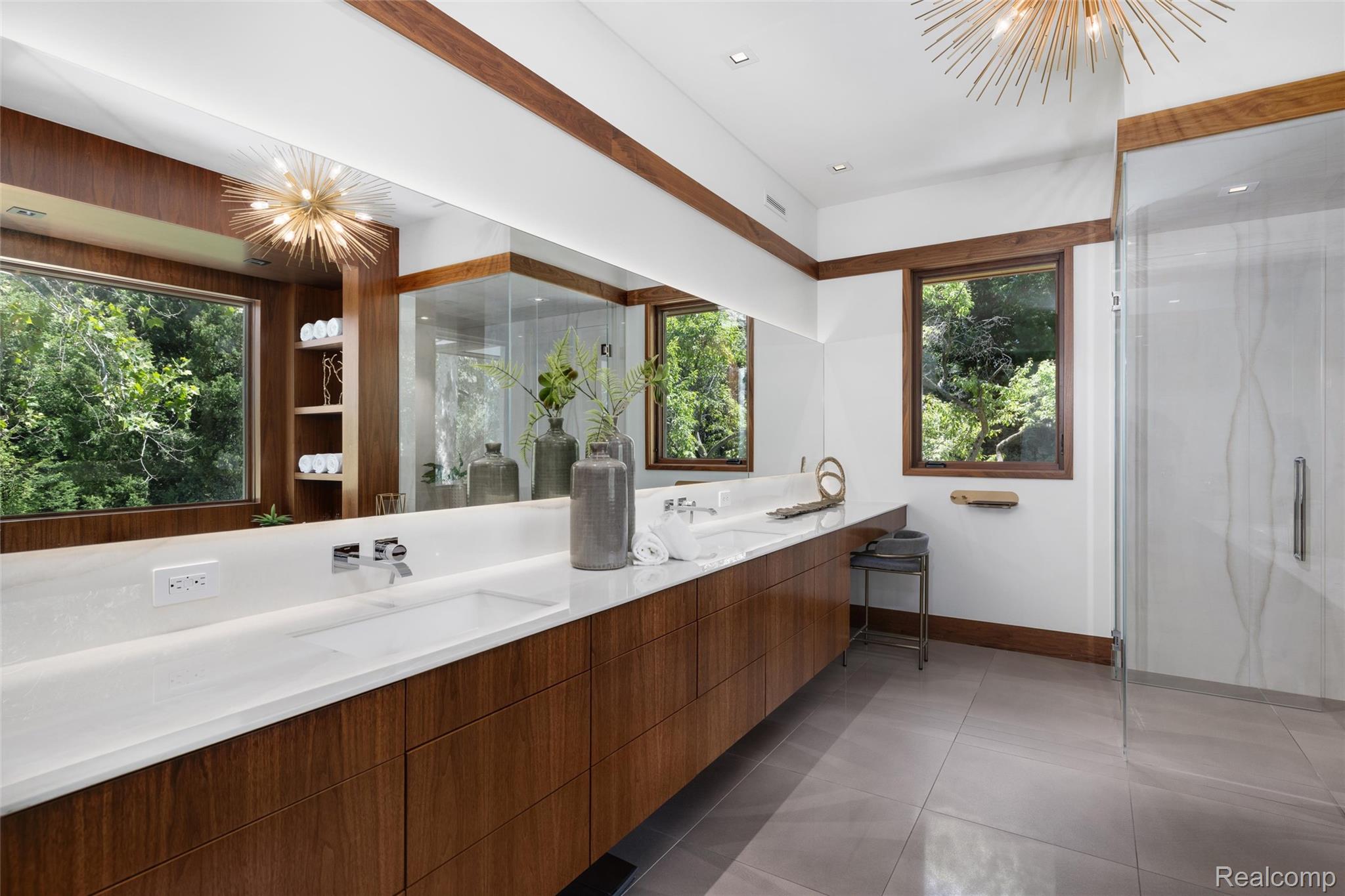2700 Squirrel Road Bloomfield Hills, MI 48304 - Photo 32 of 83 Expansive bathroom featuring a long wood-finish vanity with dual integrated sinks and a continuous white countertop