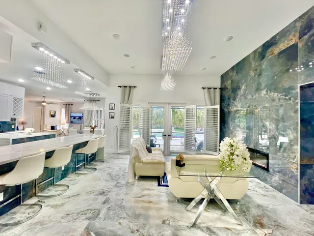 a living room with dining table furniture dining table and a large window