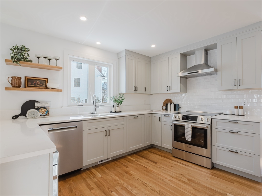 75 Foster Road, Unit 1 Belmont, MA 02478 - Photo 15 of 38 a kitchen with white cabinets stainless steel appliances and sink