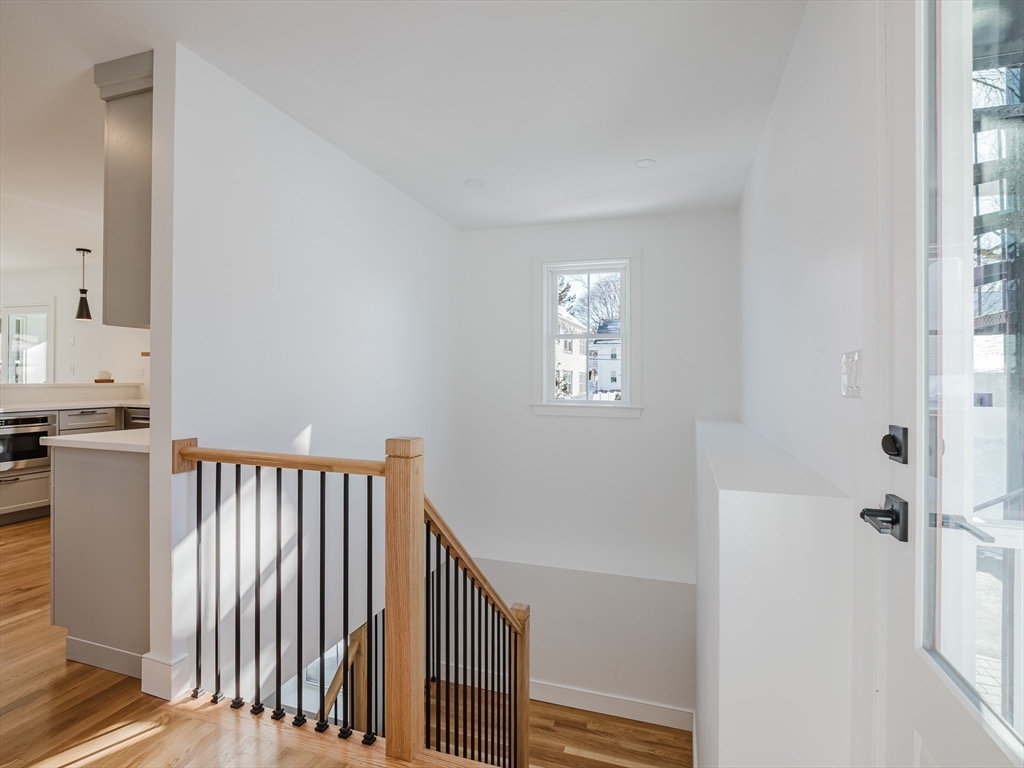 75 Foster Road, Unit 1 Belmont, MA 02478 - Photo 21 of 38 a view of a hallway with windows and stairs