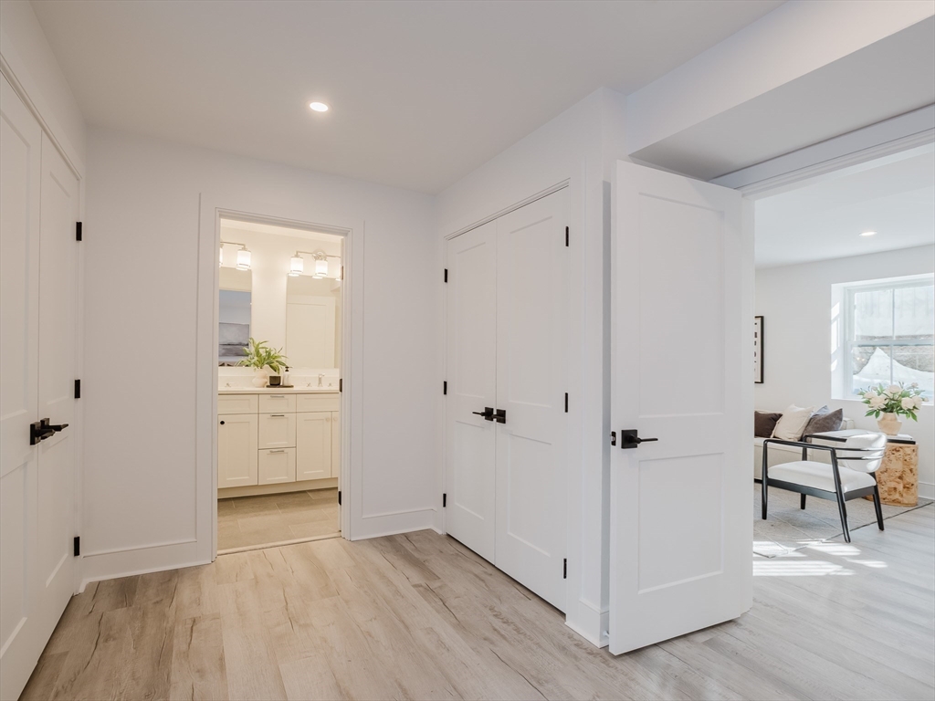 75 Foster Road, Unit 1 Belmont, MA 02478 - Photo 34 of 38 a view of a kitchen with white cabinets and wooden floor