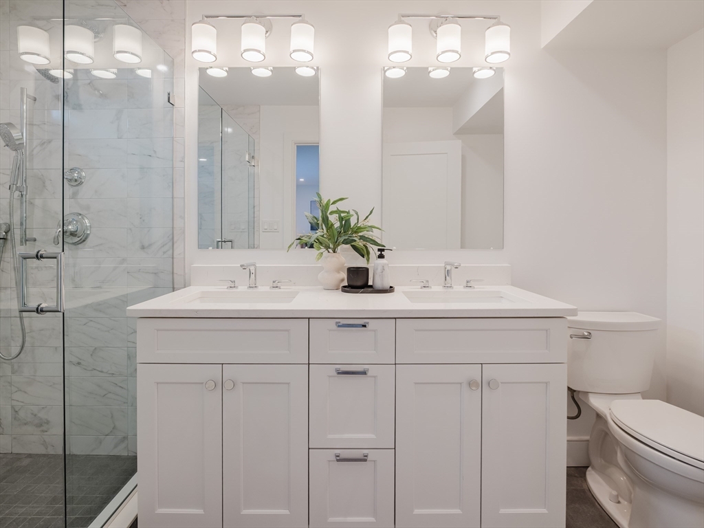 75 Foster Road, Unit 1 Belmont, MA 02478 - Photo 35 of 38 a bathroom with a sink vanity granite and toilet