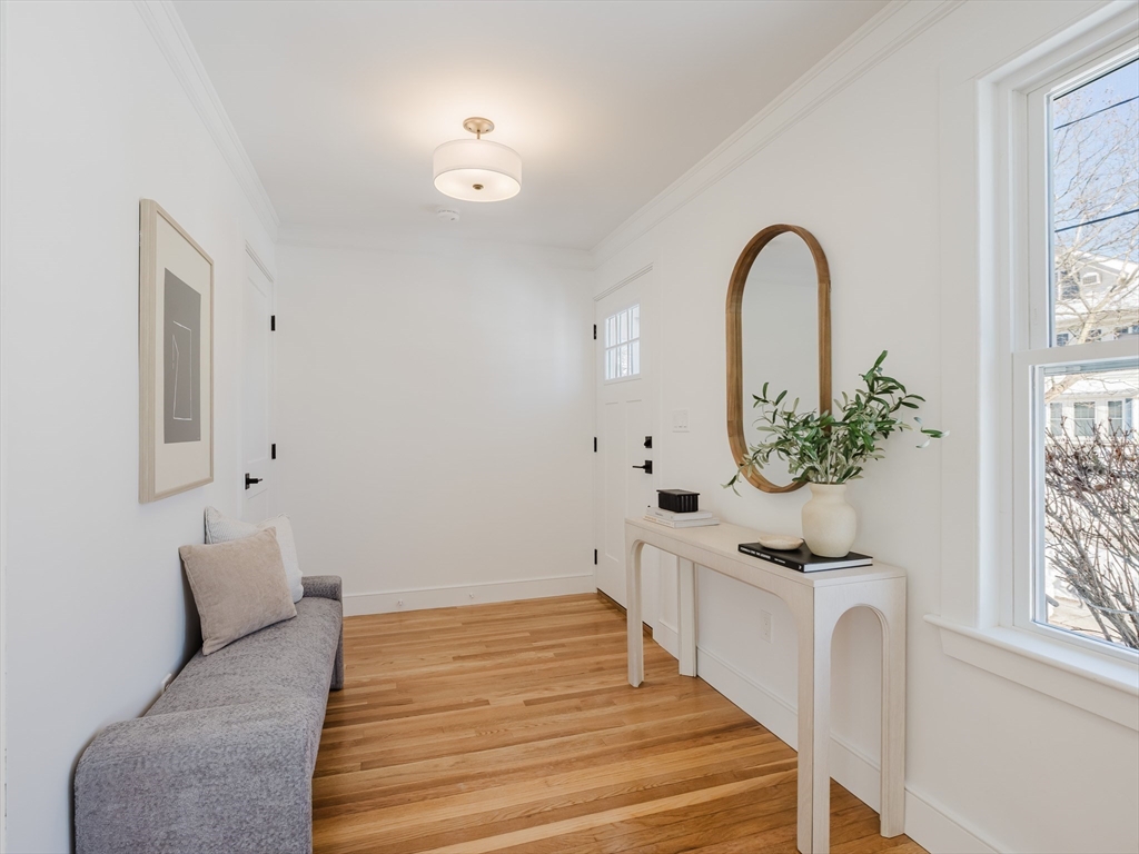 75 Foster Road, Unit 1 Belmont, MA 02478 - Photo 5 of 38 a bedroom with a bed and a potted plant
