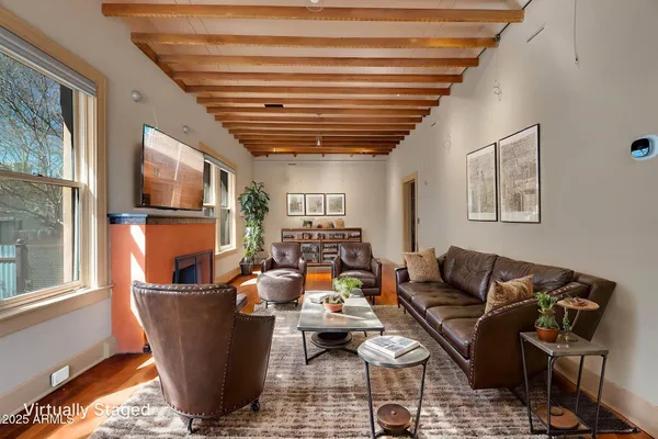 a kitchen with a refrigerator a stove top oven a sink and a potted plant