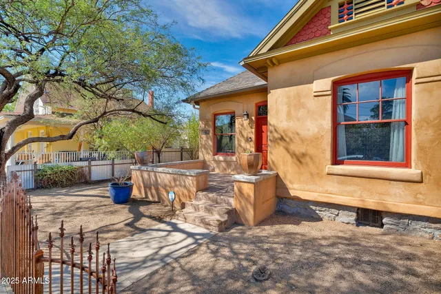 a view of a house with backyard and sitting area