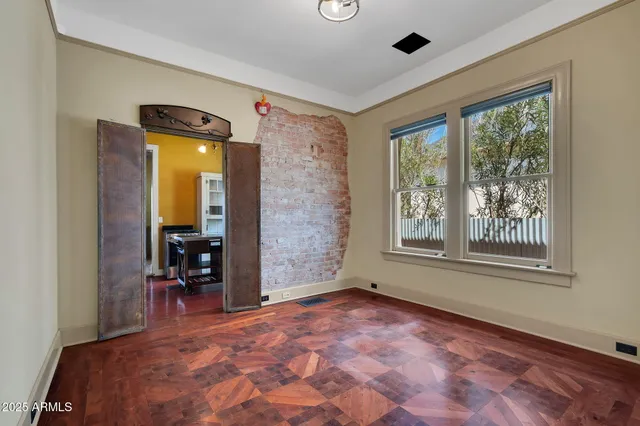 a view of a livingroom with wooden floor and a ceiling fan