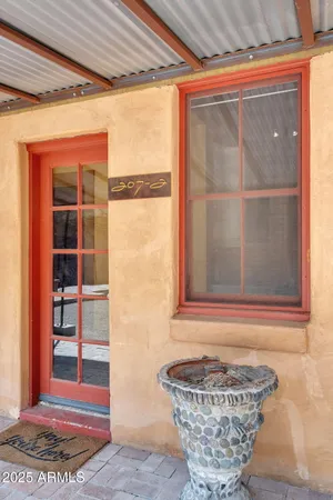 a balcony with wooden floor and furniture