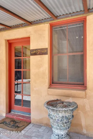 a balcony with wooden floor and furniture
