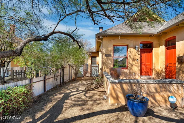 a living room with a fireplace and windows