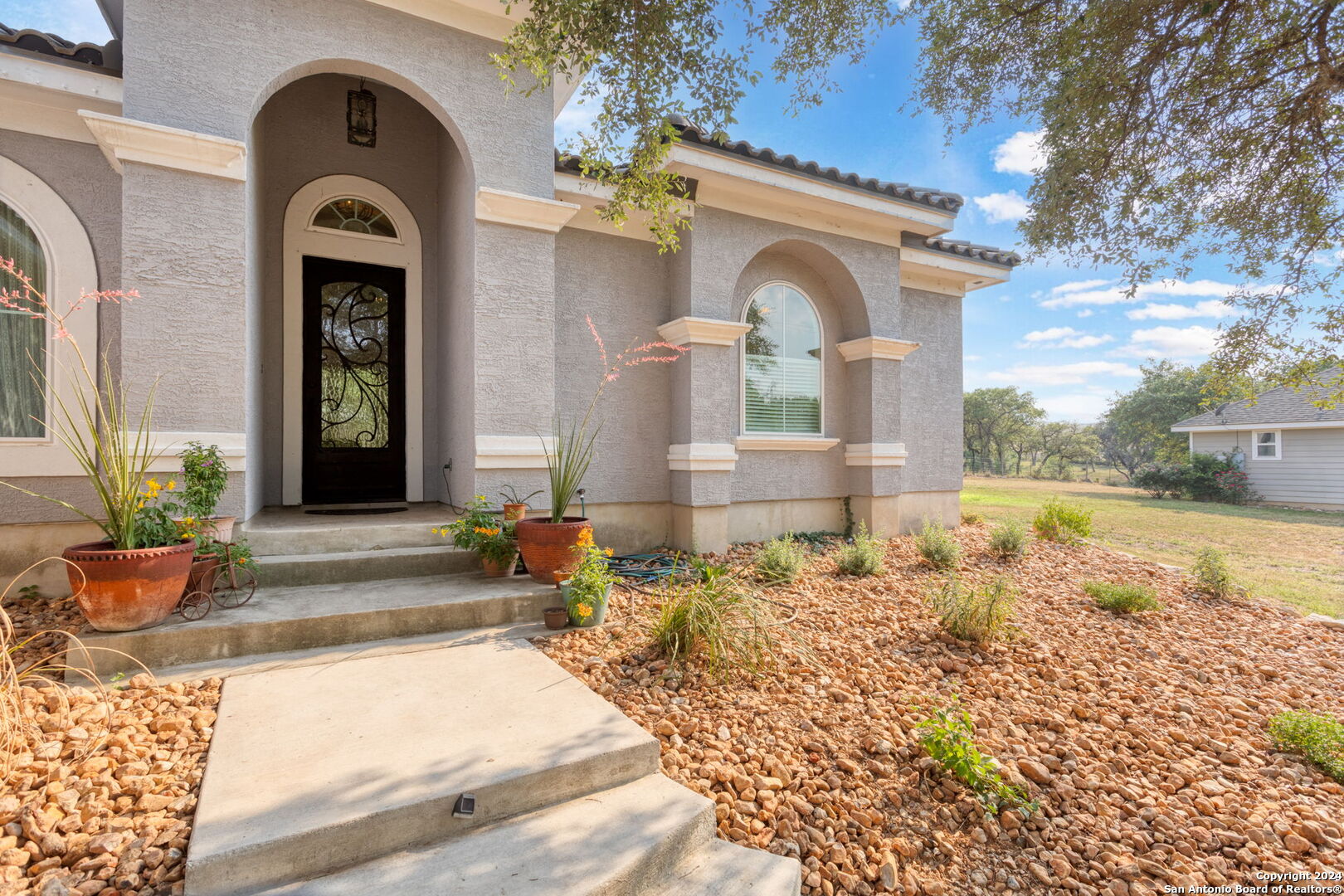 a front view of a house with garden