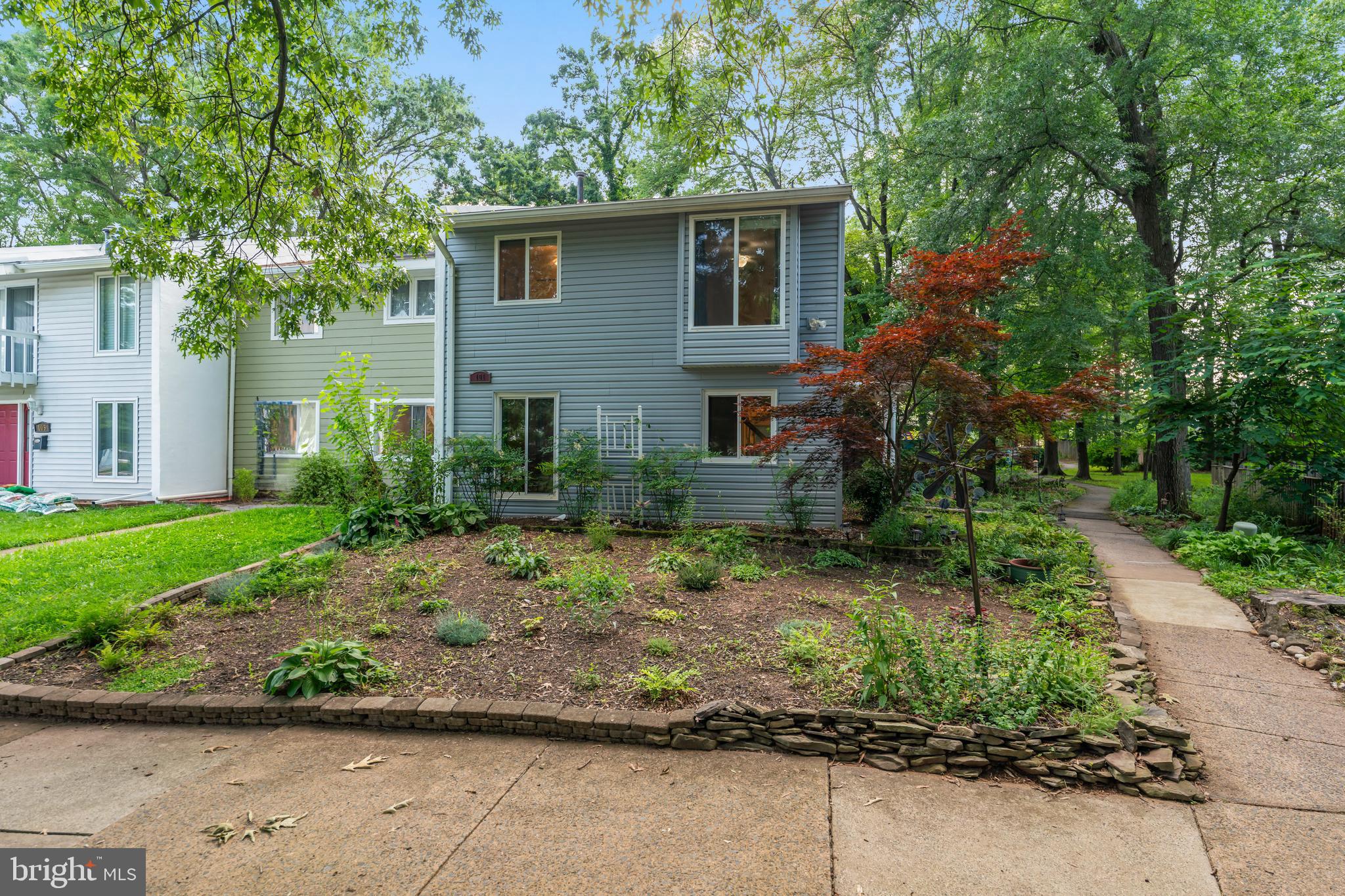 101 Hayloft Circle Sterling, VA 20164 - Photo 2 of 39 a front view of a house with a garden