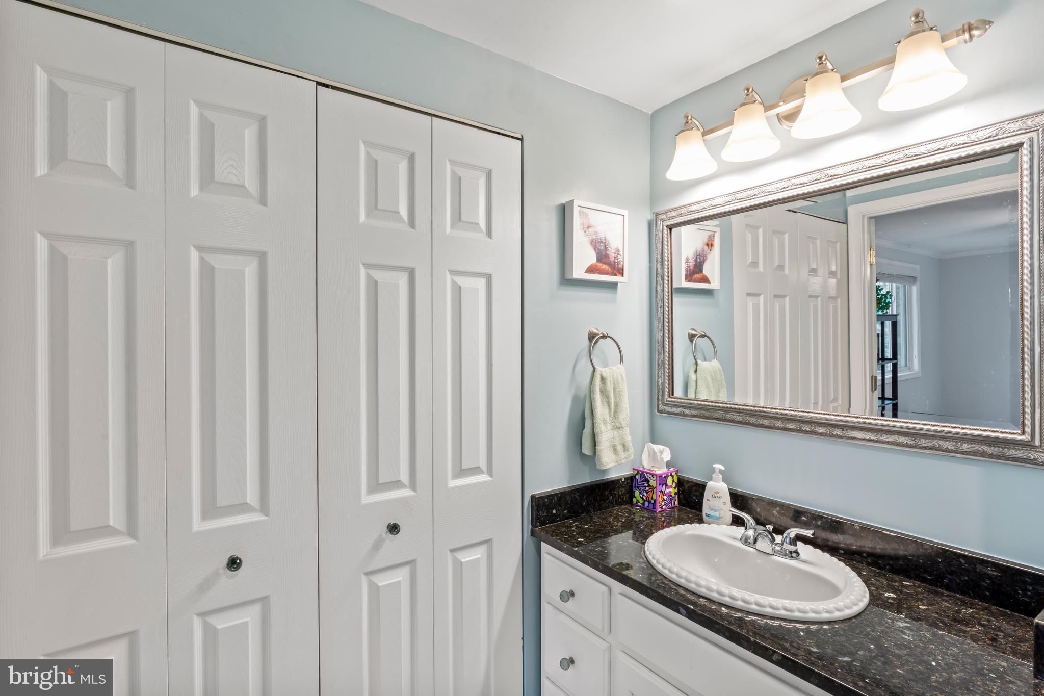 101 Hayloft Circle Sterling, VA 20164 - Photo 22 of 39 a bathroom with a granite countertop sink vanity mirror and a