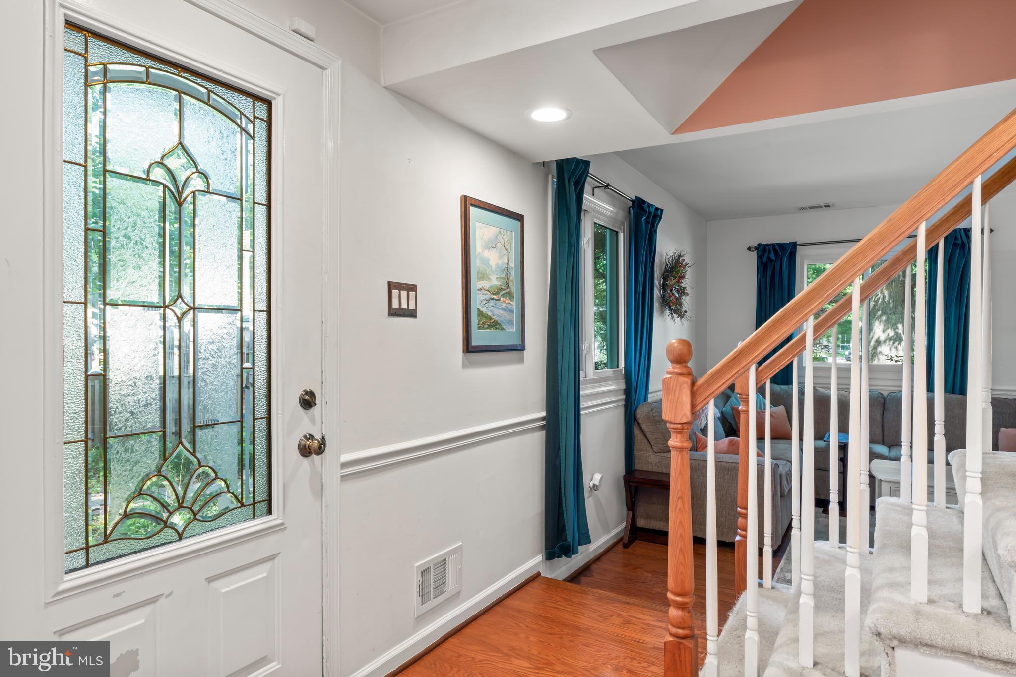 101 Hayloft Circle Sterling, VA 20164 - Photo 6 of 39 a view of an entryway with wooden floor and windows