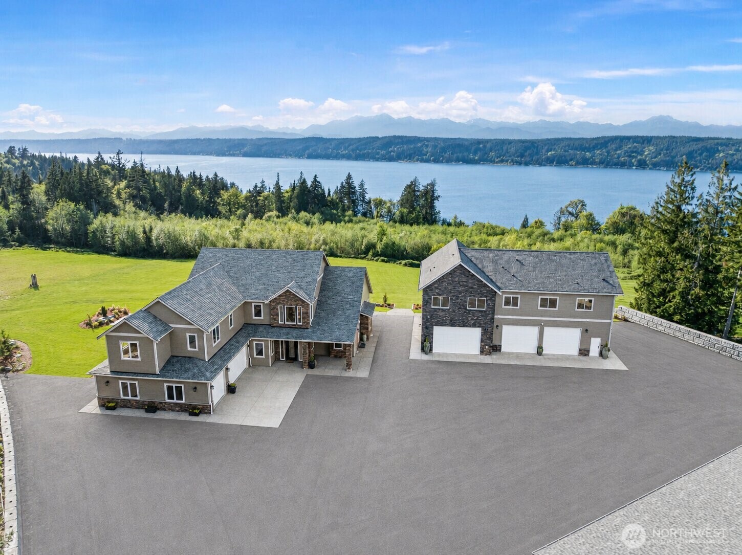 151 East Windy Ridge Lane Belfair, WA 98528 - Photo 2 of 40 an aerial view of a house with outdoor space and a lake view in back