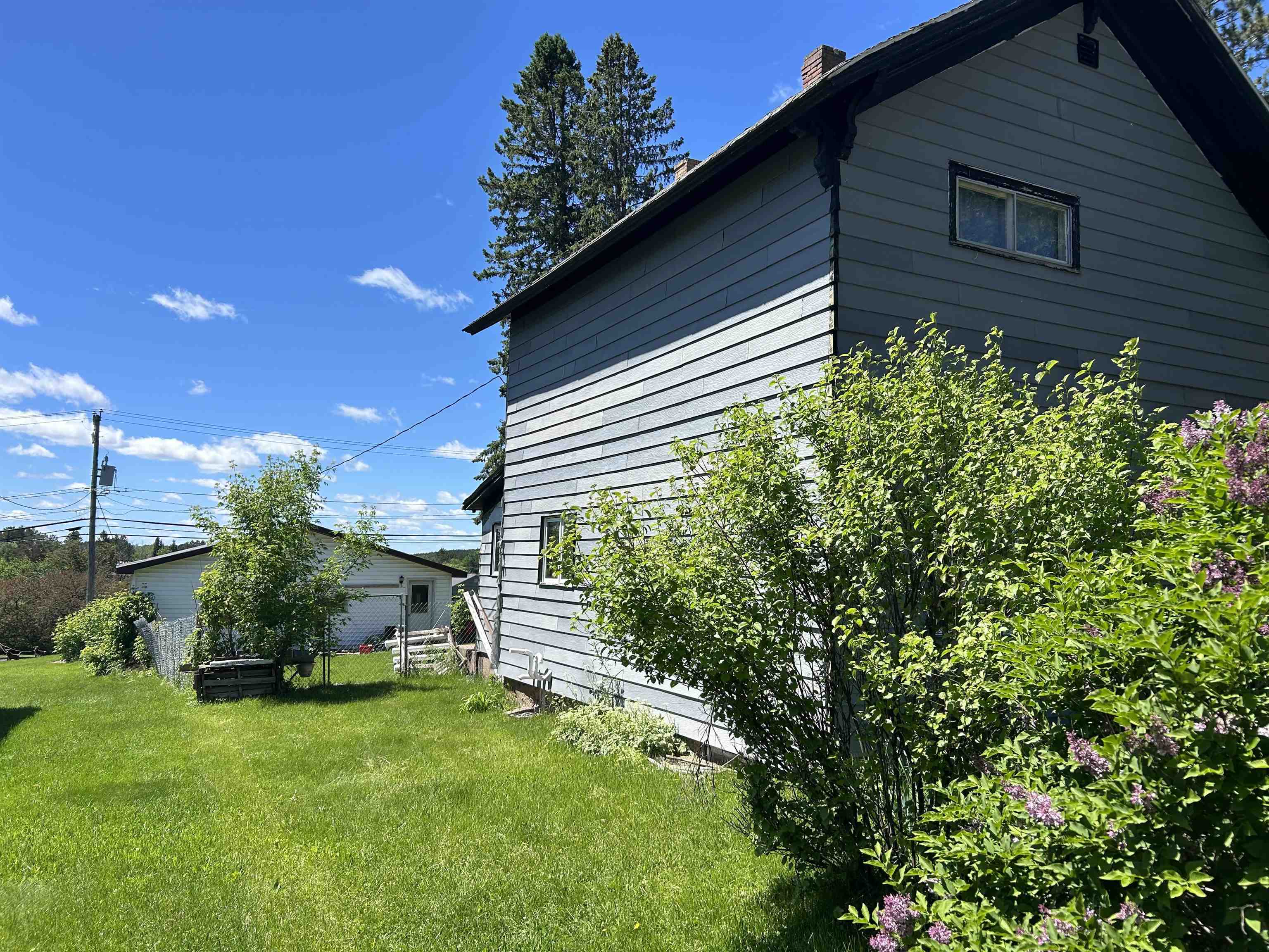 157 East 2nd Street Glidden, WI 54527 - Photo 13 of 15 View of property exterior featuring a lawn