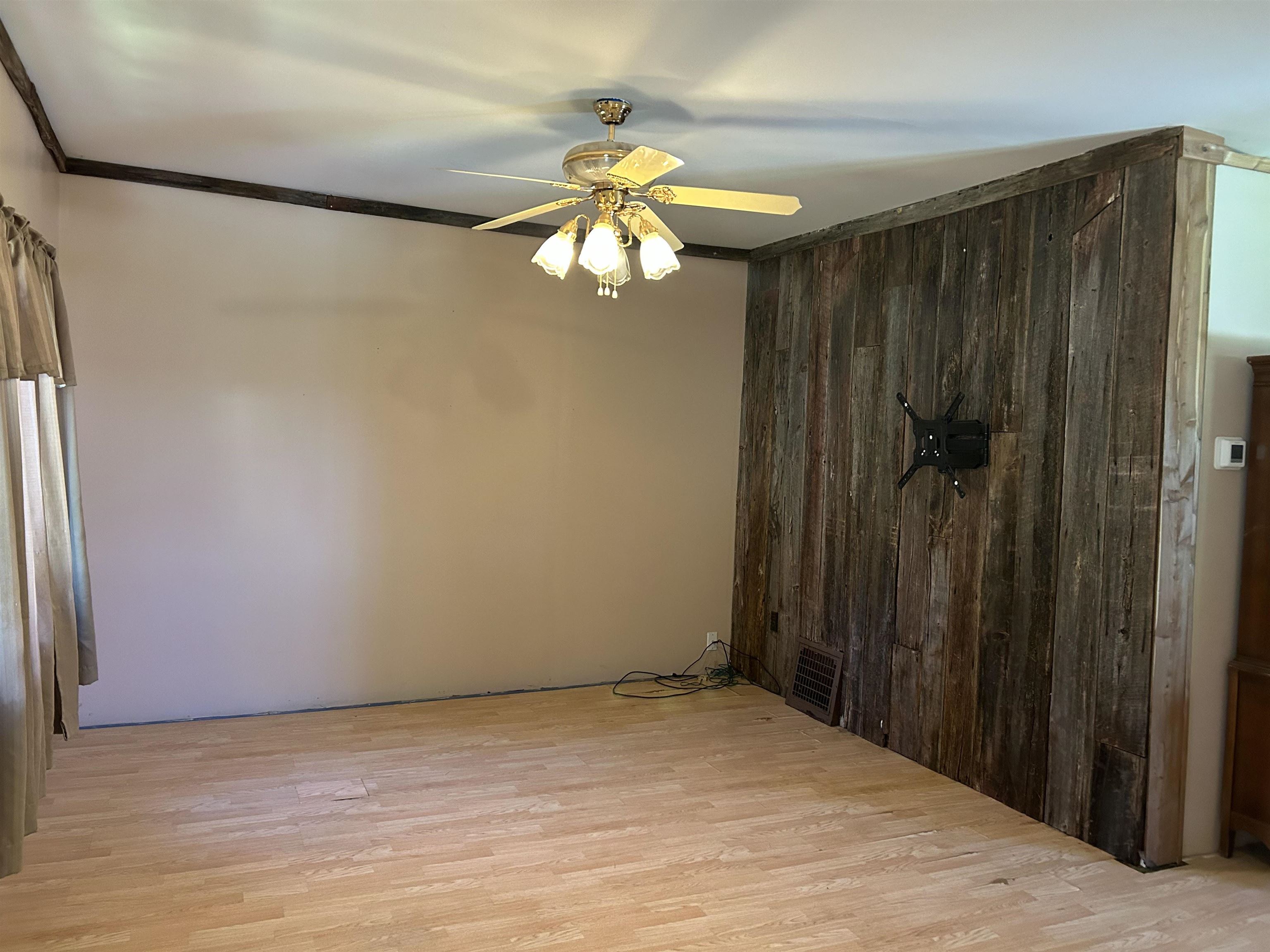 157 East 2nd Street Glidden, WI 54527 - Photo 2 of 15 Unfurnished room featuring crown molding, light wood-type flooring, and ceiling fan