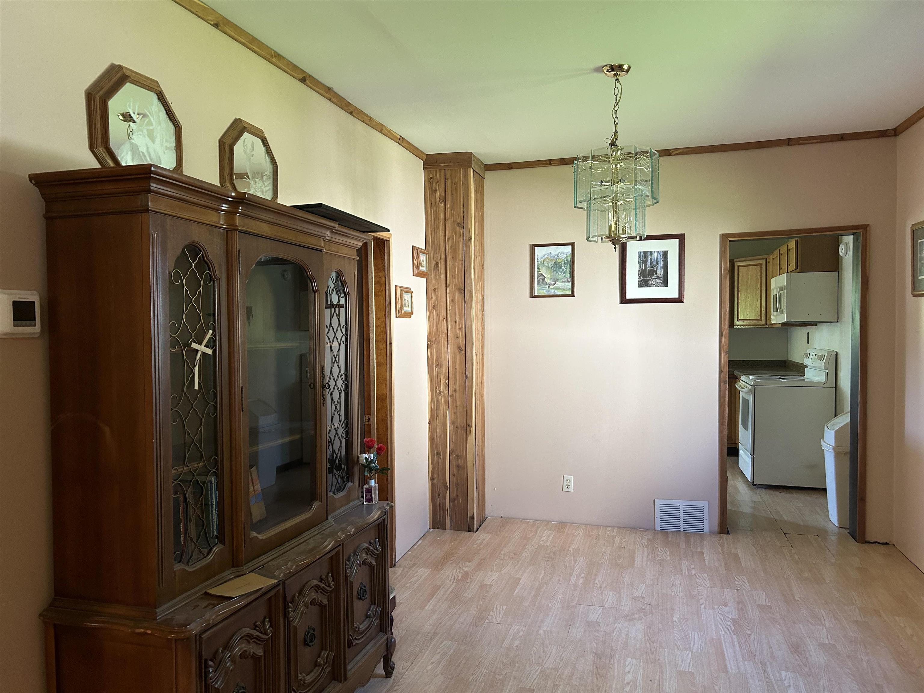 157 East 2nd Street Glidden, WI 54527 - Photo 3 of 15 Interior space featuring ornamental molding, an inviting chandelier, and hardwood / wood-style flooring