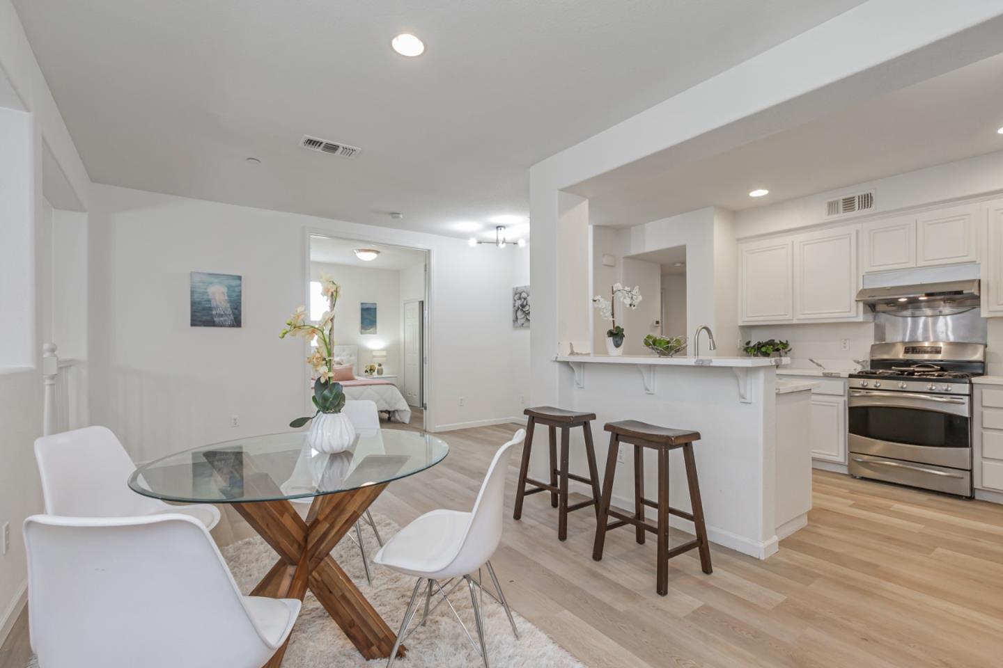 1744 Snell Place Milpitas, CA 95035 - Photo 12 of 35 a kitchen with a dining table chairs and white cabinets