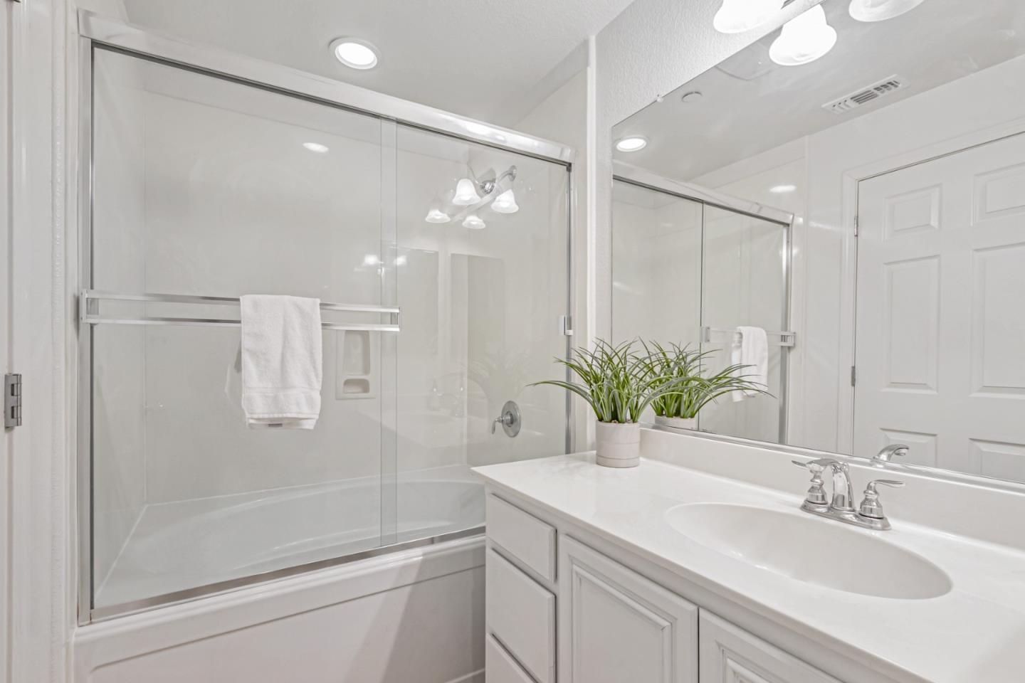 1744 Snell Place Milpitas, CA 95035 - Photo 23 of 35 a bathroom with a sink a shower and a mirror