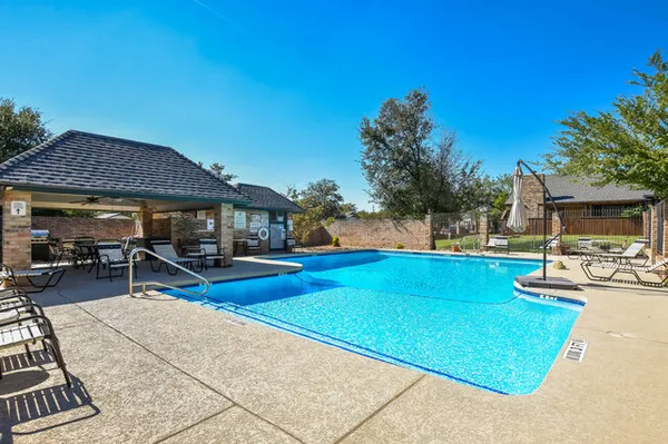 a view of a house with swimming pool and sitting area